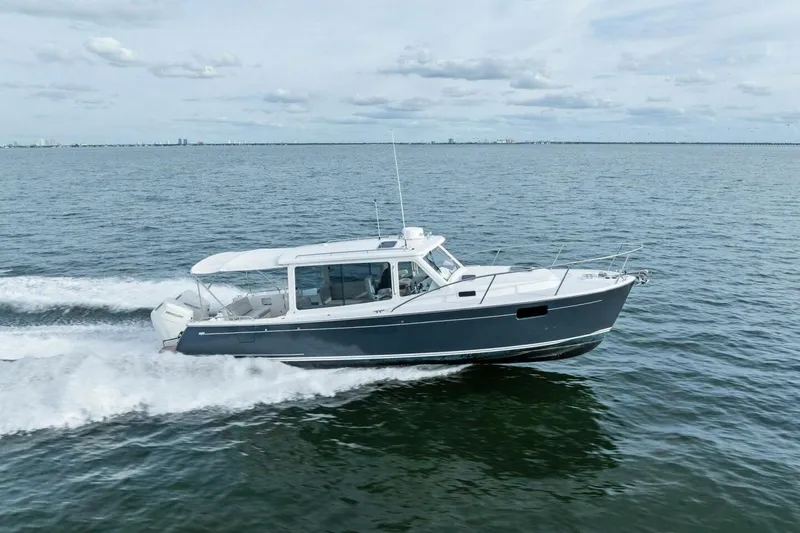 Slide: The Image of 2025 MJM 35 boat cruising on open water under a cloudy sky. - 51