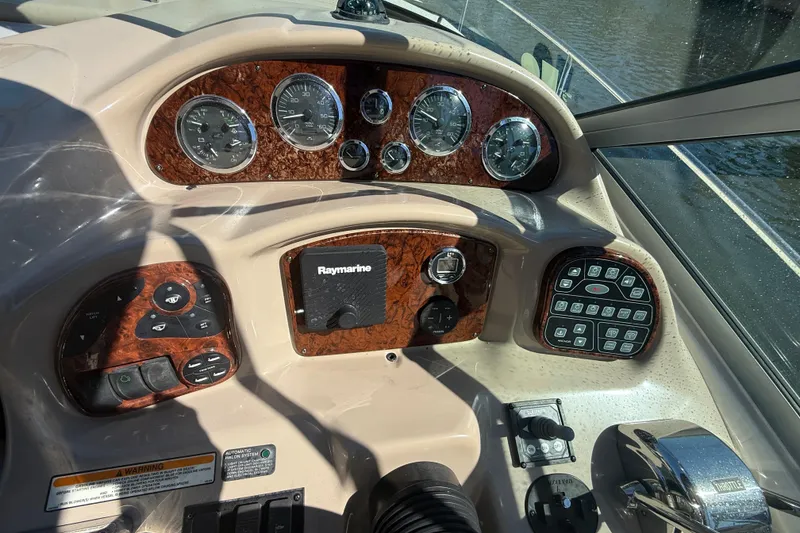 Slide: The Image of Dashboard of a 2003 Sea Ray 320 Sundancer boat with gauges and controls. - 15