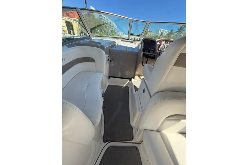 Slide: The Image of Interior view of 2003 Sea Ray 320 Sundancer boat with white seating and dashboard. - 18