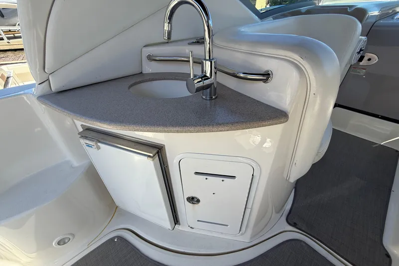 Slide: The Image of 2003 Sea Ray 320 Sundancer boat interior with sink and mini fridge. - 22