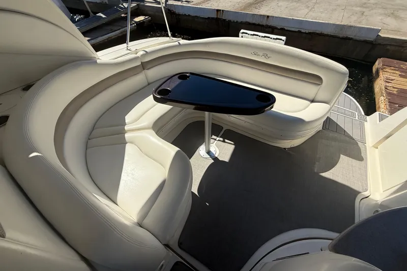 Slide: The Image of 2003 Sea Ray 320 Sundancer boat interior with curved seating and table. - 23