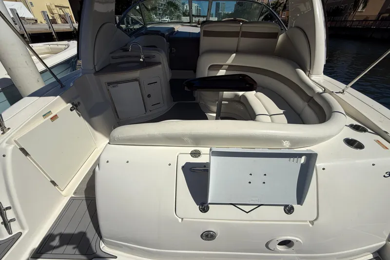 Slide: The Image of 2003 Sea Ray 320 Sundancer boat interior with seating and kitchenette area. - 24