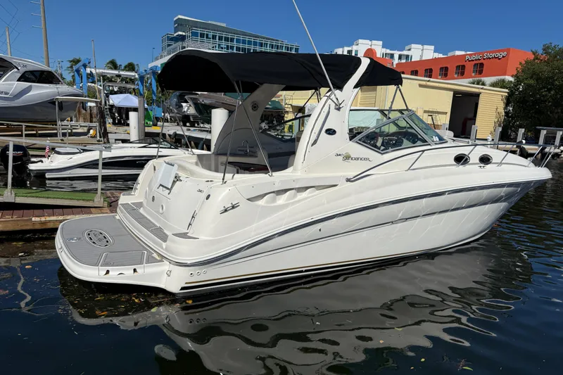 Slide: The Image of 2003 Sea Ray 320 Sundancer boat docked at marina under clear blue sky. - 4