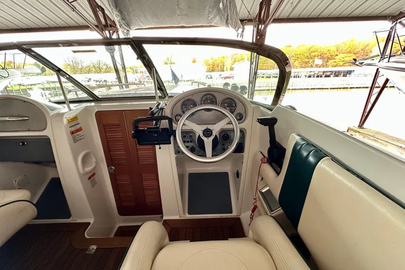 Slide: The Image of 2003 Chris-Craft Corsair 25 boat interior with steering wheel and dashboard controls. - 11