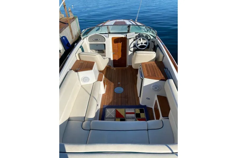 Slide: The Image of 2003 Chris-Craft Corsair 25 boat interior with elegant seating and wooden accents. - 3