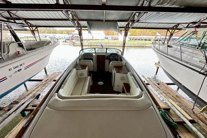 Slide: The Image of 2003 Chris-Craft Corsair 25 boat docked in a covered marina, interior view. - 4