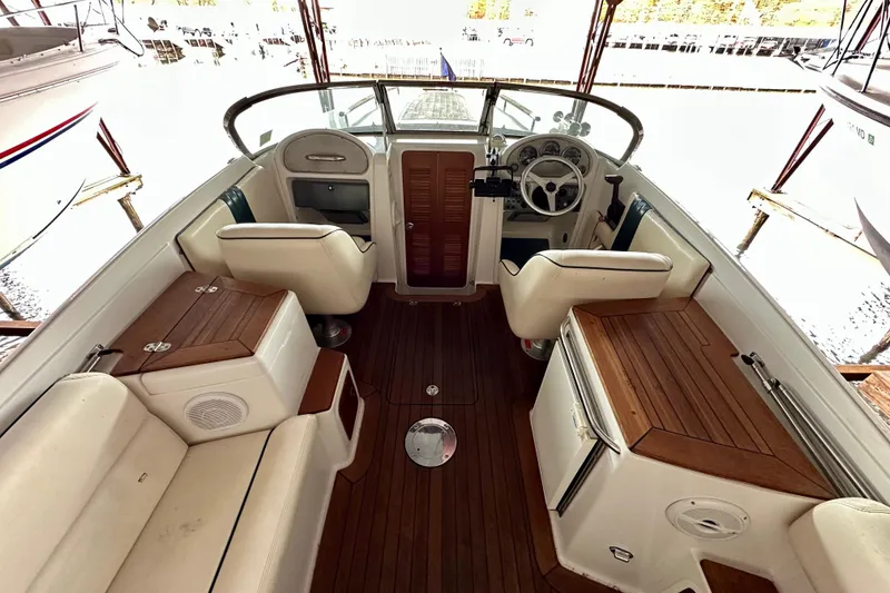 Slide: The Image of Interior of 2003 Chris-Craft Corsair 25 boat with wooden accents and white seating. - 6