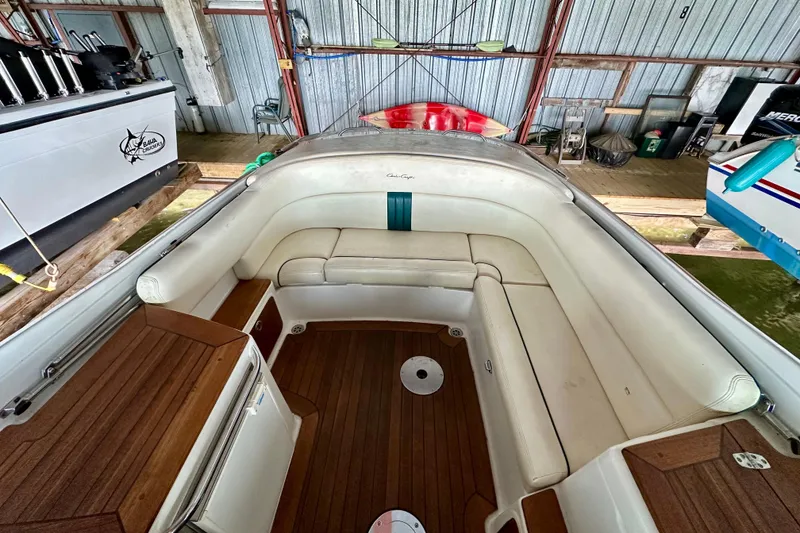 Slide: The Image of 2003 Chris-Craft Corsair 25 boat interior with white seating and wooden flooring. - 7