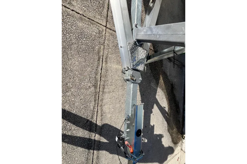 Slide: The Image of Trailer hitch of a 2026 Pioneer 202 Sportfish boat on concrete surface. - 11