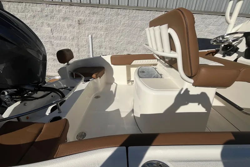 Slide: The Image of 2026 Pioneer 202 Sportfish boat interior with brown seating and modern design. - 18