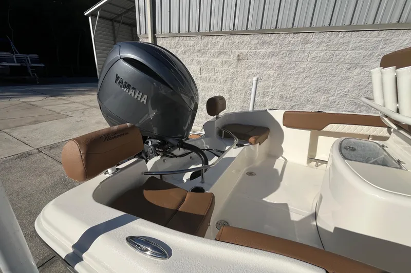 Slide: The Image of 2026 Pioneer 202 Sportfish boat with Yamaha engine, featuring brown seating and white interior. - 5
