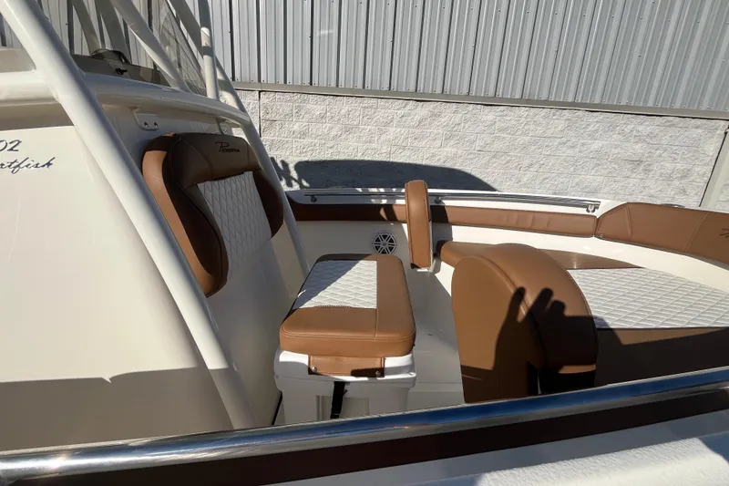 Slide: The Image of 2026 Pioneer 202 Sportfish boat interior with brown and white cushioned seating. - 9