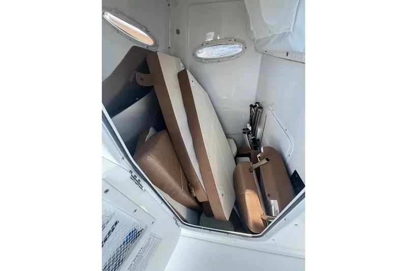 Slide: The Image of 2023 Sea Hunt Ultra 305 SE boat console with steering wheel and navigation screens. - 11