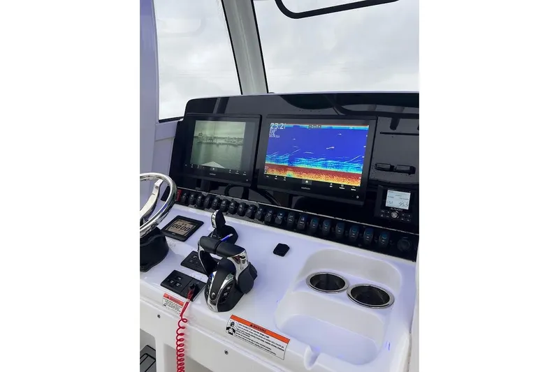 Slide: The Image of 2023 Sea Hunt Ultra 305 SE boat dashboard with advanced navigation displays. - 15
