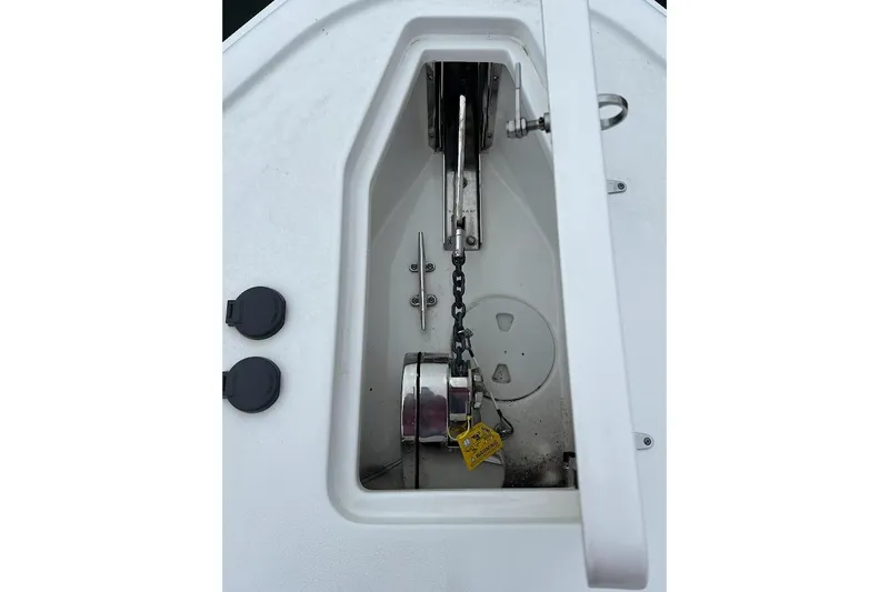 Slide: The Image of Anchor compartment of 2023 Sea Hunt Ultra 305 SE boat, featuring chain and hardware. - 20