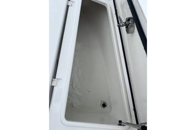 Slide: The Image of 2023 Sea Hunt Ultra 305 SE storage compartment, open and empty. - 23
