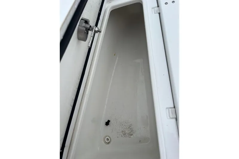 Slide: The Image of Storage compartment of 2023 Sea Hunt Ultra 305 SE boat, open and empty. - 24