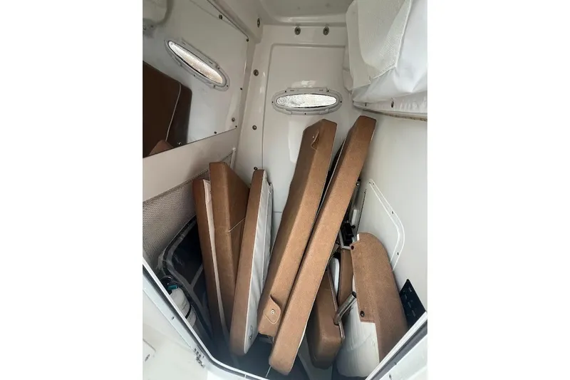 Slide: The Image of 2023 Sea Hunt Ultra 305 SE cabin interior with stacked cushions. - 25