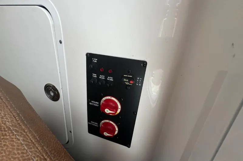 Slide: The Image of Control panel on 2023 Sea Hunt Ultra 305 SE boat, featuring battery switches and indicators. - 26