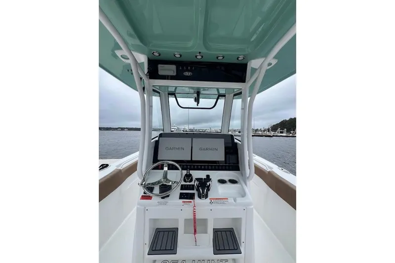 Slide: The Image of 2023 Sea Hunt Ultra 305 SE boat console with Garmin navigation system on open water. - 29