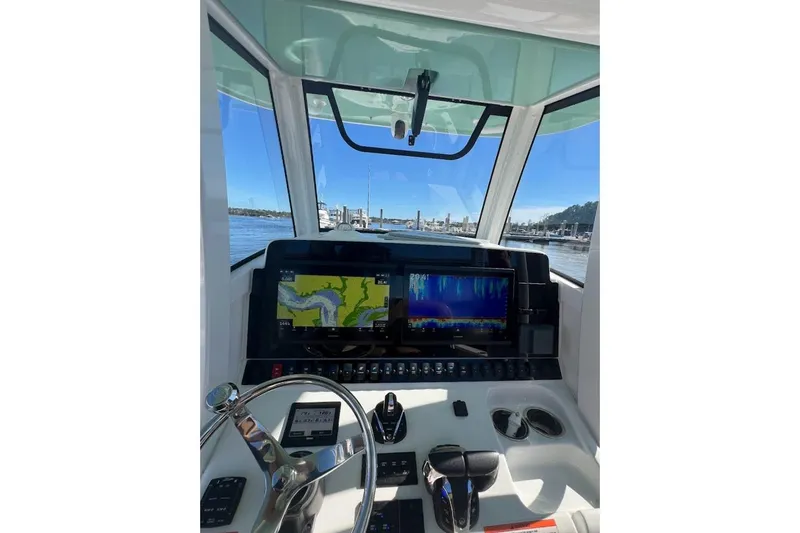 Slide: The Image of 2023 Sea Hunt Ultra 305 SE boat interior with Garmin equipment and overhead lighting. - 3