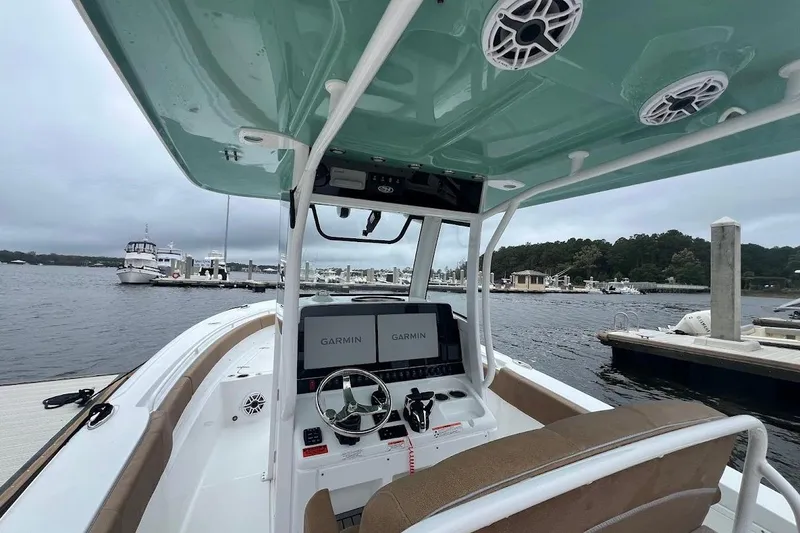 Slide: The Image of 2023 Sea Hunt Ultra 305 SE boat interior with Garmin navigation, docked at marina. - 30