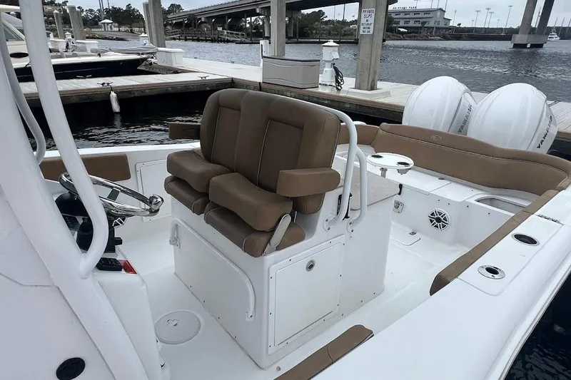 Slide: The Image of 2023 Sea Hunt Ultra 305 SE boat interior with dual seats and steering console. - 35