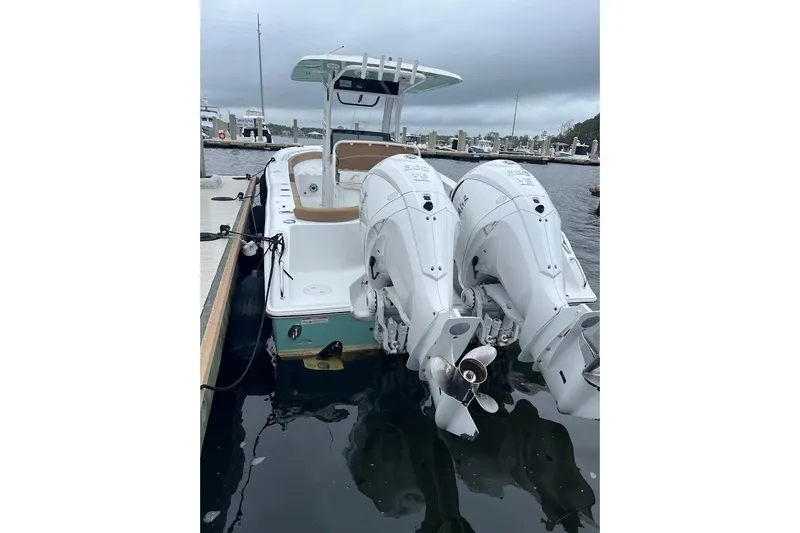 Slide: The Image of 2023 Sea Hunt Ultra 305 SE boat docked with dual outboard engines. - 36