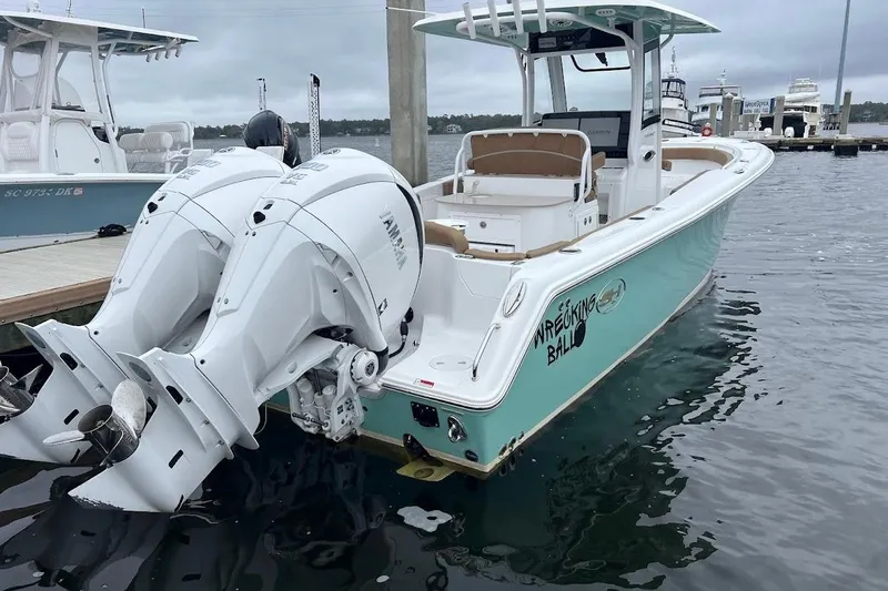 Slide: The Image of 2023 Sea Hunt Ultra 305 SE boat docked with twin Yamaha engines. - 37