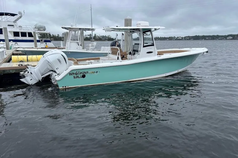 Slide: The Image of 2023 Sea Hunt Ultra 305 SE boat docked on a cloudy day. - 38