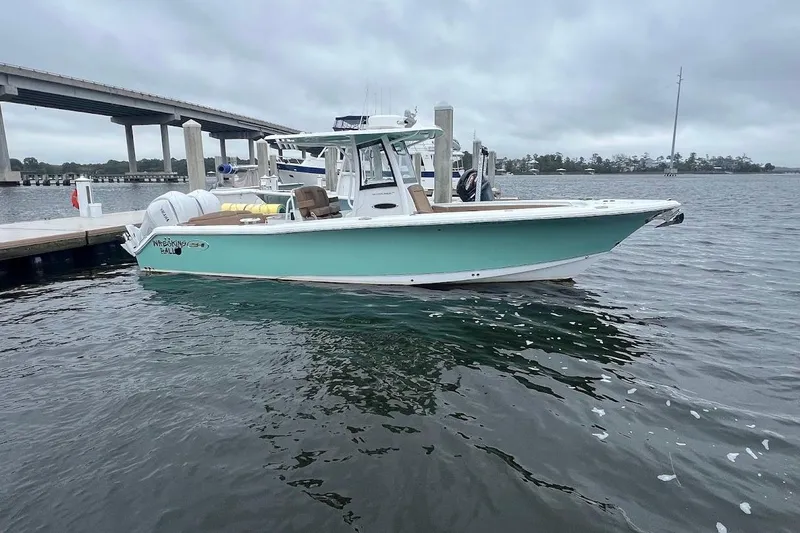 Slide: The Image of 2023 Sea Hunt Ultra 305 SE boat docked on a cloudy day. - 39