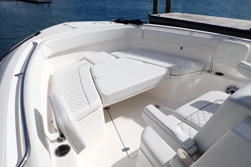 Slide: The Image of 2024 Pursuit S 288 Sport boat interior with luxurious white seating and diamond stitching. - 10