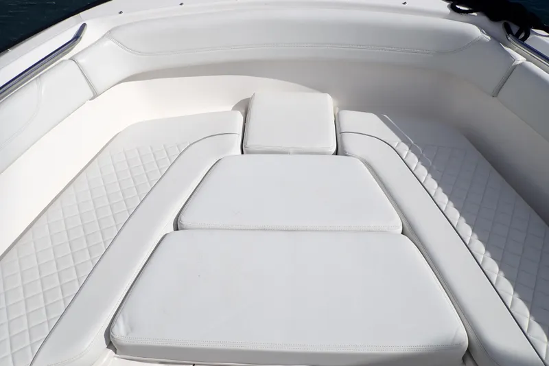 Slide: The Image of 2024 Pursuit S 288 Sport boat with luxurious white cushioned seating. - 13