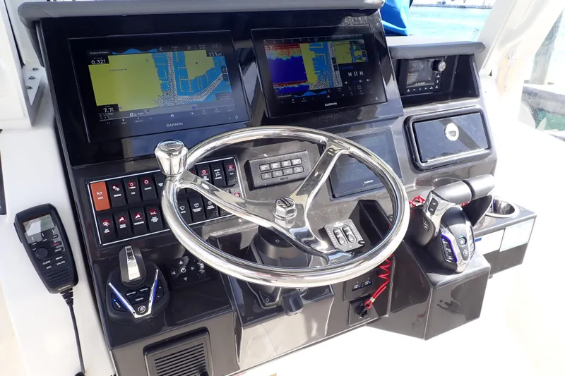 Slide: The Image of 2024 Pursuit S 288 Sport boat dashboard with advanced navigation and control systems. - 16