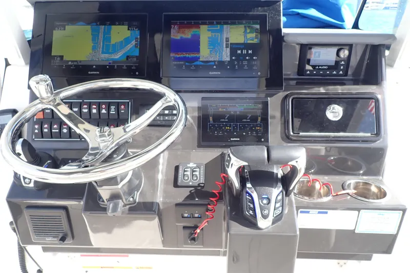 Slide: The Image of 2024 Pursuit S 288 Sport boat dashboard with Garmin displays and steering wheel. - 17