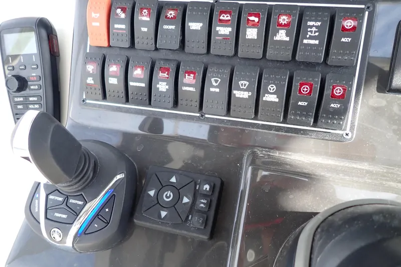 Slide: The Image of Control panel of 2024 Pursuit S 288 Sport boat with switches and joystick. - 19
