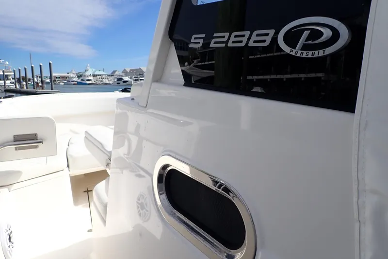 Slide: The Image of 2024 Pursuit S 288 Sport boat docked at marina, showcasing sleek design. - 21