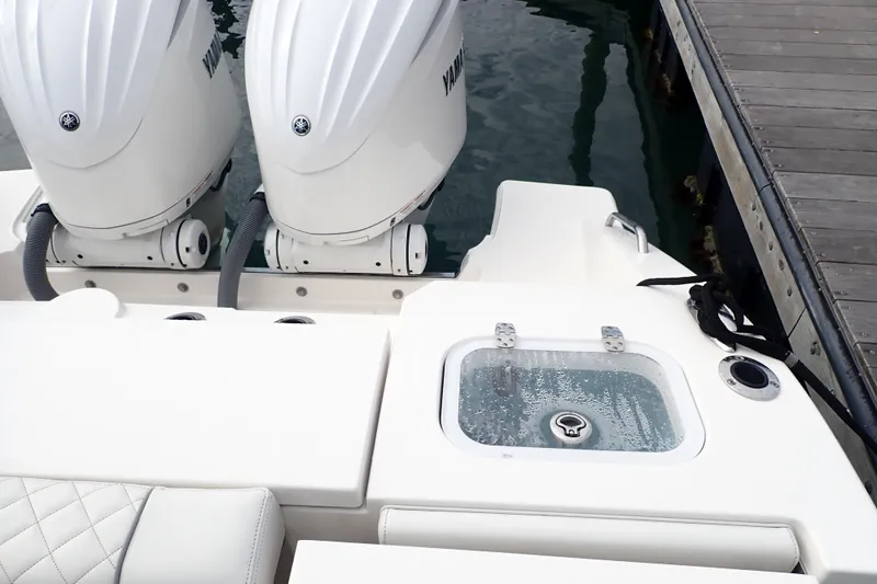 Slide: The Image of 2024 Pursuit S 288 Sport boat with dual Yamaha engines at dock. - 25