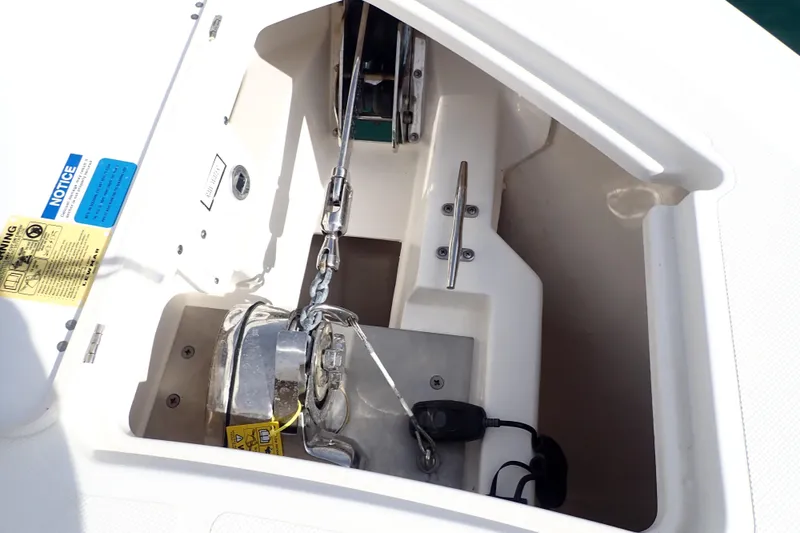 Slide: The Image of Anchor compartment of 2024 Pursuit S 288 Sport boat, featuring chain and winch. - 29