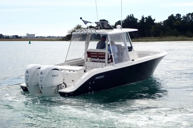 Slide: The Image of 2024 Pursuit S 288 Sport boat cruising on water with twin Yamaha engines. - 32