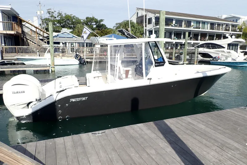 Slide: The Image of 2024 Pursuit S 288 Sport boat docked at marina with Yamaha engine. - 4
