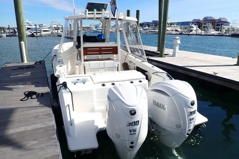 Slide: The Image of 2024 Pursuit S 288 Sport boat docked with twin Yamaha 300 V6 engines. - 5