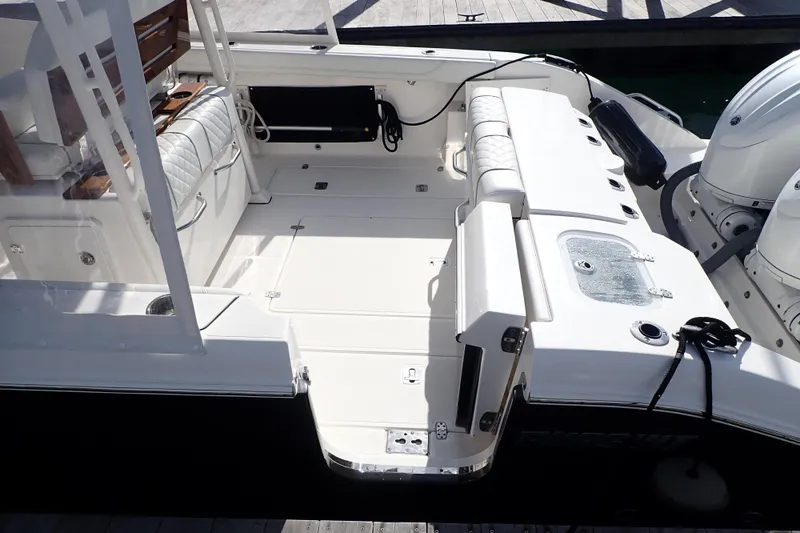 Slide: The Image of 2024 Pursuit S 288 Sport boat interior with seating and dual engines. - 6