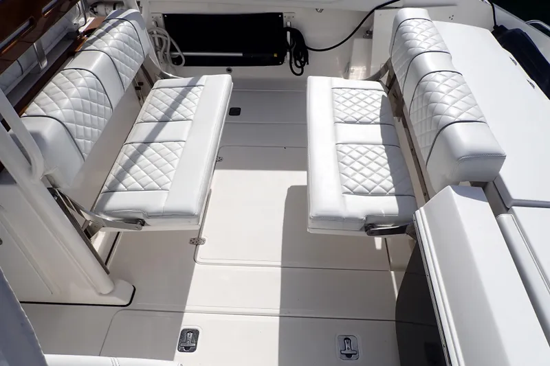Slide: The Image of 2024 Pursuit S 288 Sport boat interior with white quilted seating and sleek design. - 7