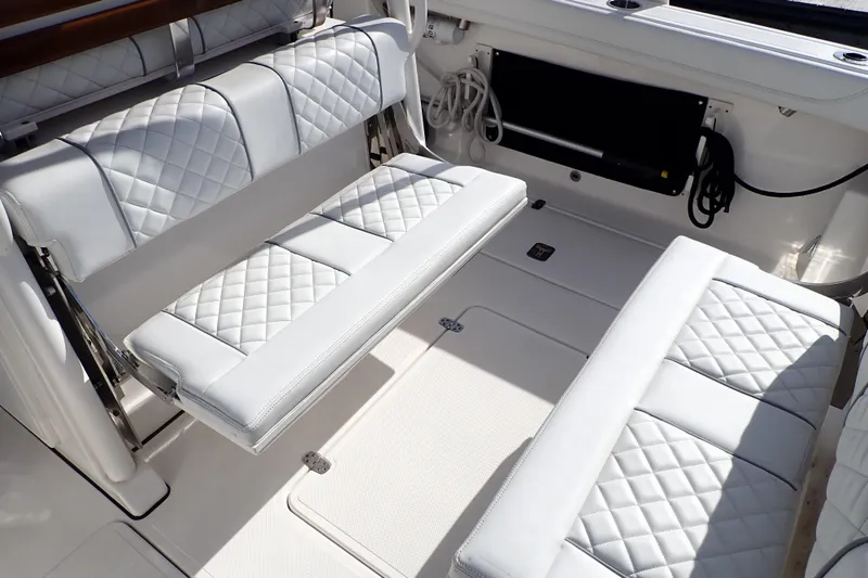 Slide: The Image of 2024 Pursuit S 288 Sport boat interior with white quilted seating. - 8