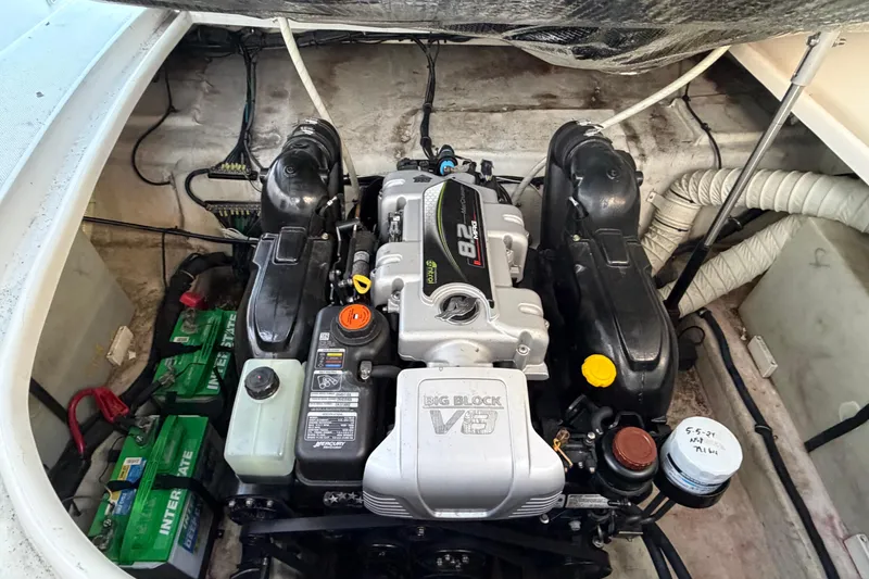 Slide: The Image of Engine compartment of a 2015 Rinker 290 Express Cruiser with visible batteries and wiring. - 13