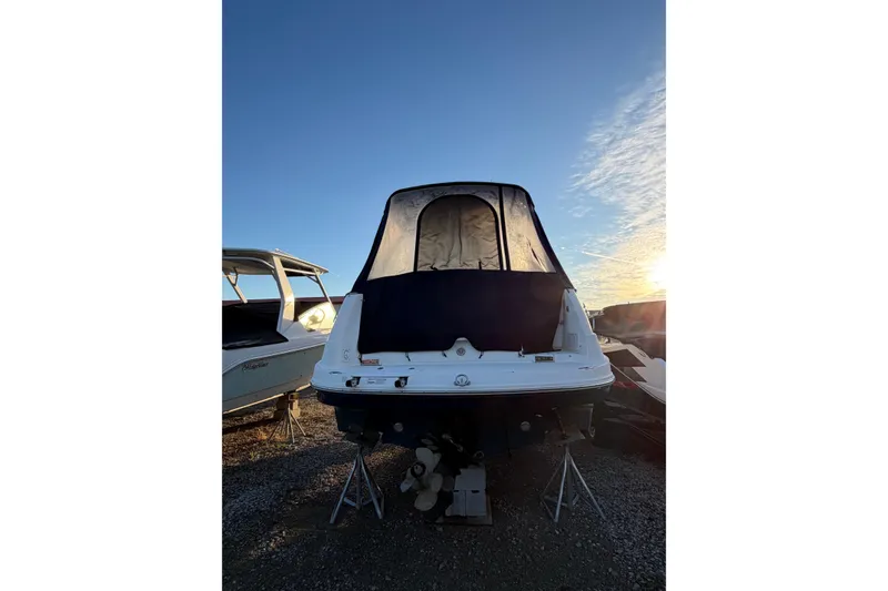 Slide: The Image of 2015 Rinker 290 Express Cruiser boat, rear view, with sunset in the background. - 3