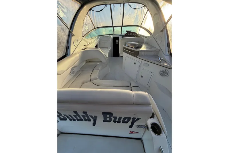Slide: The Image of 2015 Rinker 290 Express Cruiser interior with seating and helm, featuring "Buddy Buoy" text. - 4