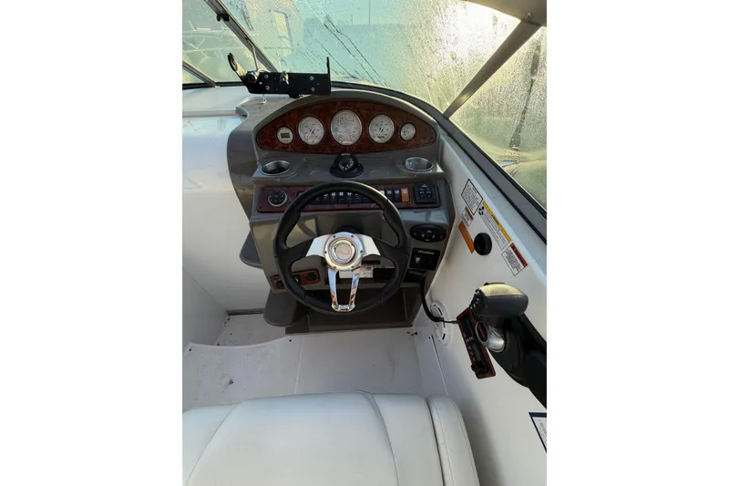 Slide: The Image of 2015 Rinker 290 Express Cruiser helm with steering wheel and instrument panel. - 6
