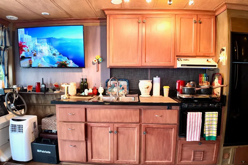 Slide: The Image of 1996 Catamaran Cruisers Aqua Cruiser 44 kitchen with wooden cabinets and modern appliances. - 15